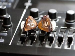 Westone Audio ES40 earphones on a music mixing console, used for professional audio mixing.